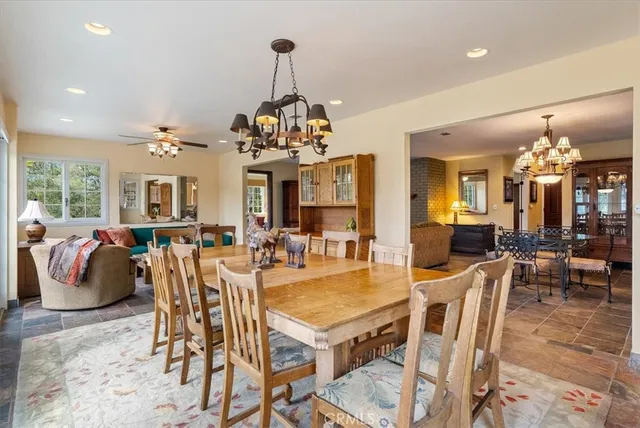 a living room with furniture ceiling fan and a large window