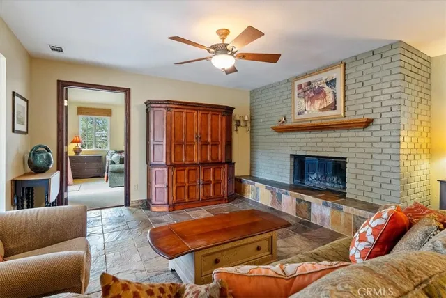 a living room with furniture ceiling fan and a window
