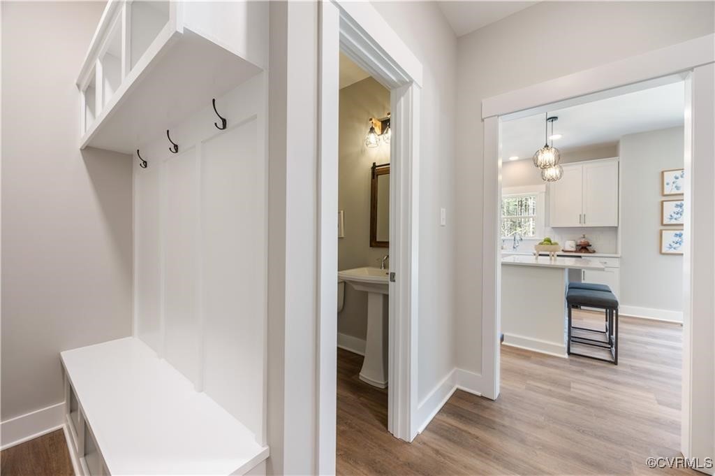 12036 Corte Castle Road Chesterfield, VA 23838 - Photo 28 of 31 a view of a hallway with wooden floor and a bathroom