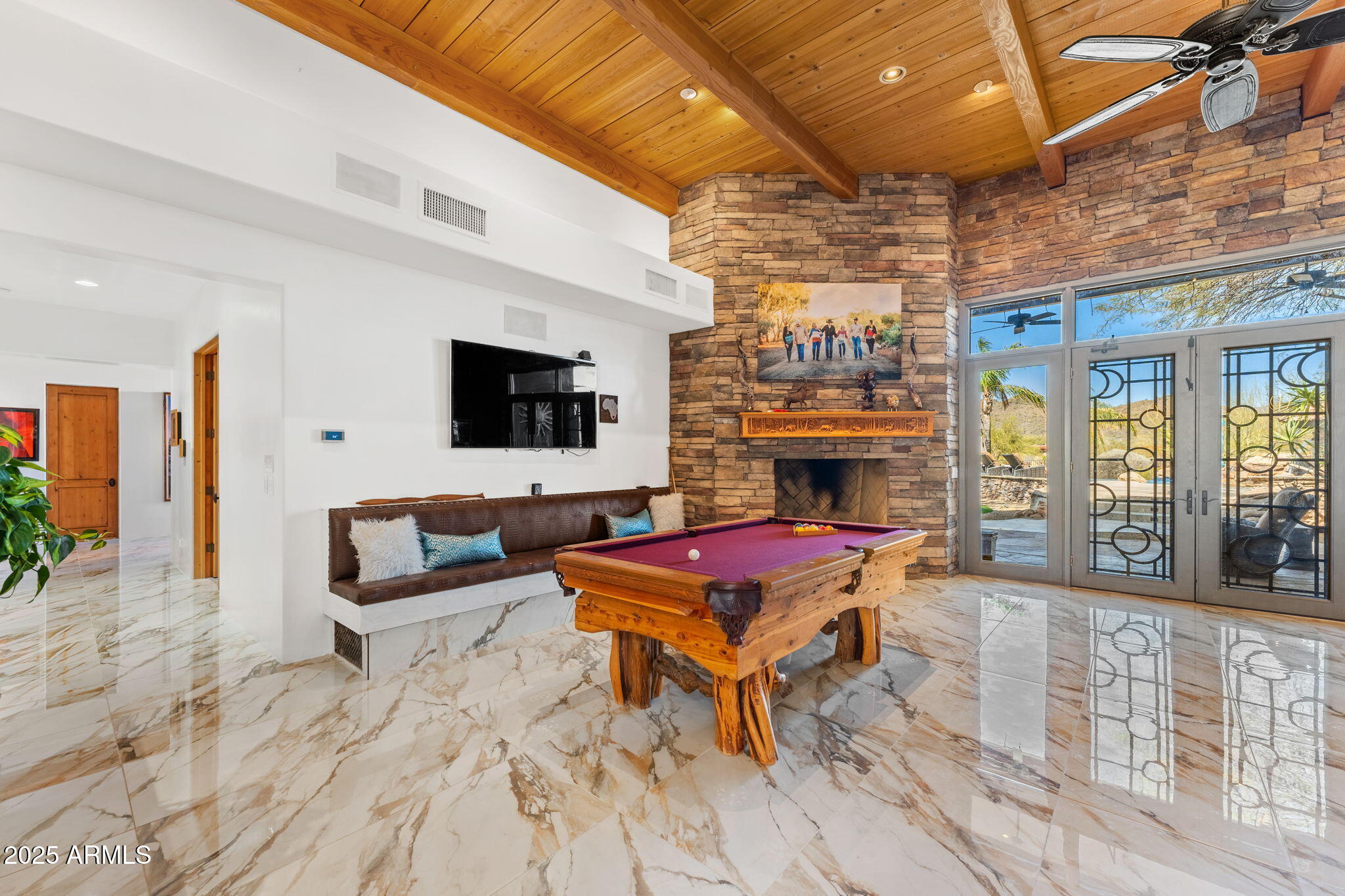 5100 East Cloud Road Cave Creek, AZ 85331 - Photo 14 of 43 a living room with furniture a flat screen tv and a fireplace