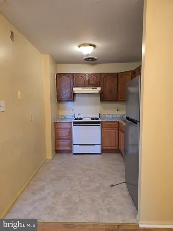 a kitchen with stainless steel appliances granite countertop a refrigerator and a stove