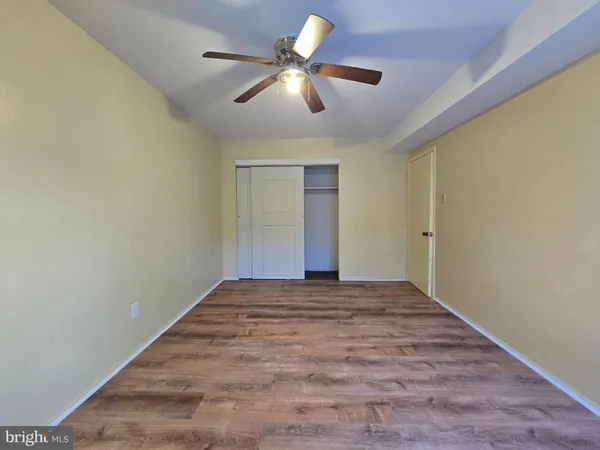 a view of room with ceiling fan and window