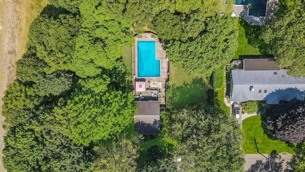 an aerial view of a house with a yard