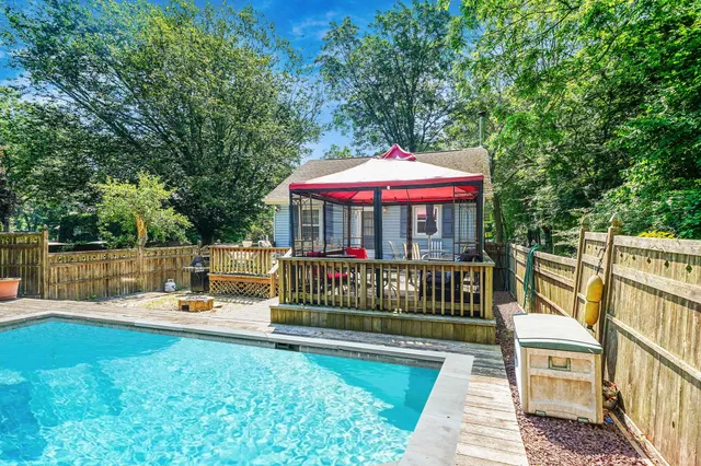 a view of a chair and table on the deck