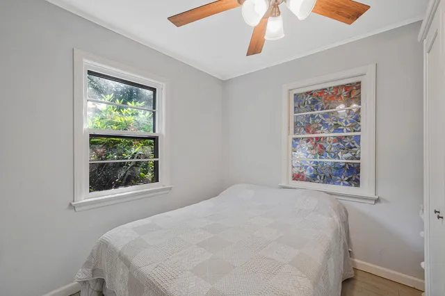 a bed sitting in a bedroom next to a window