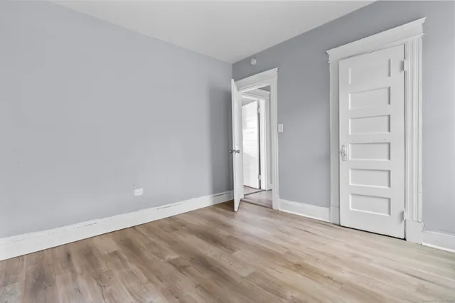 an empty room with wooden floor