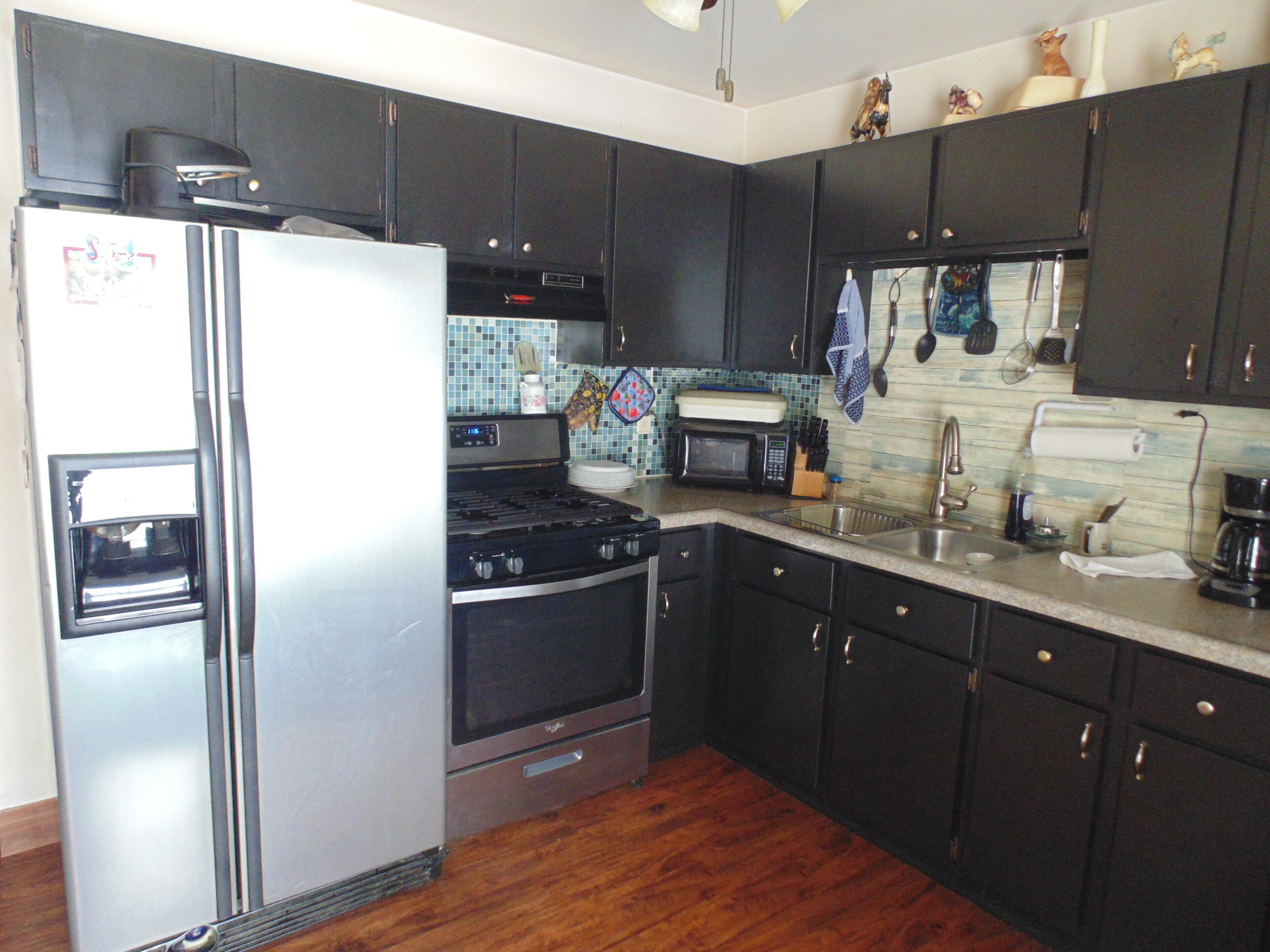 3170 Lawrence Street Hobart, IN 46342 - Photo 3 of 11 a kitchen with granite countertop a refrigerator and a sink