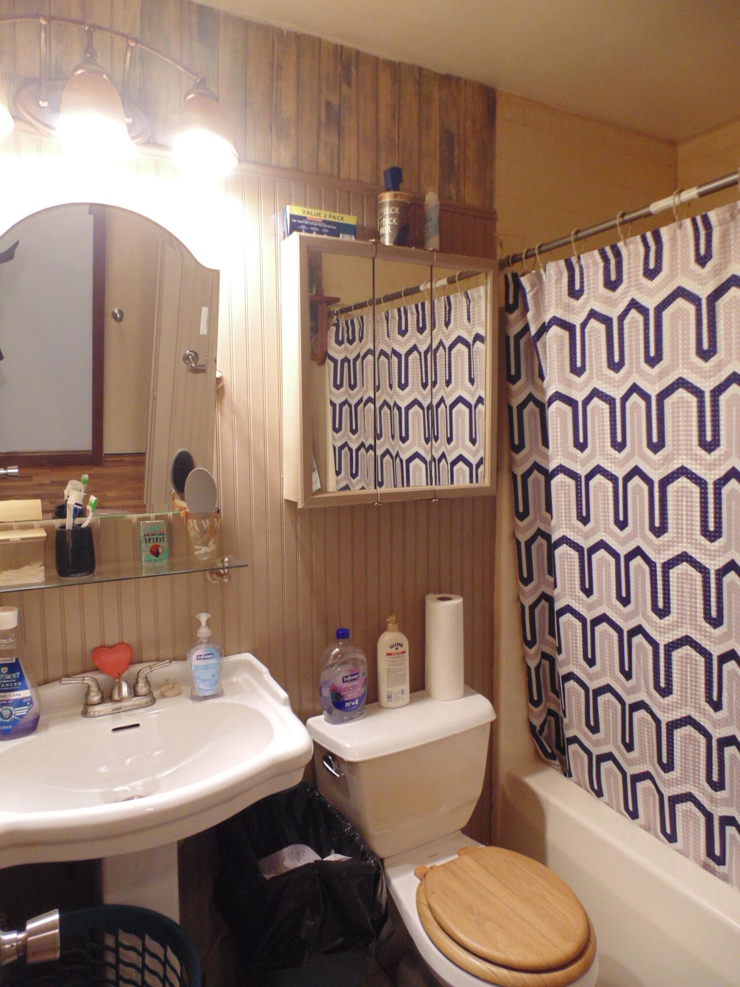 3170 Lawrence Street Hobart, IN 46342 - Photo 8 of 11 a bathroom with a toilet sink and mirror