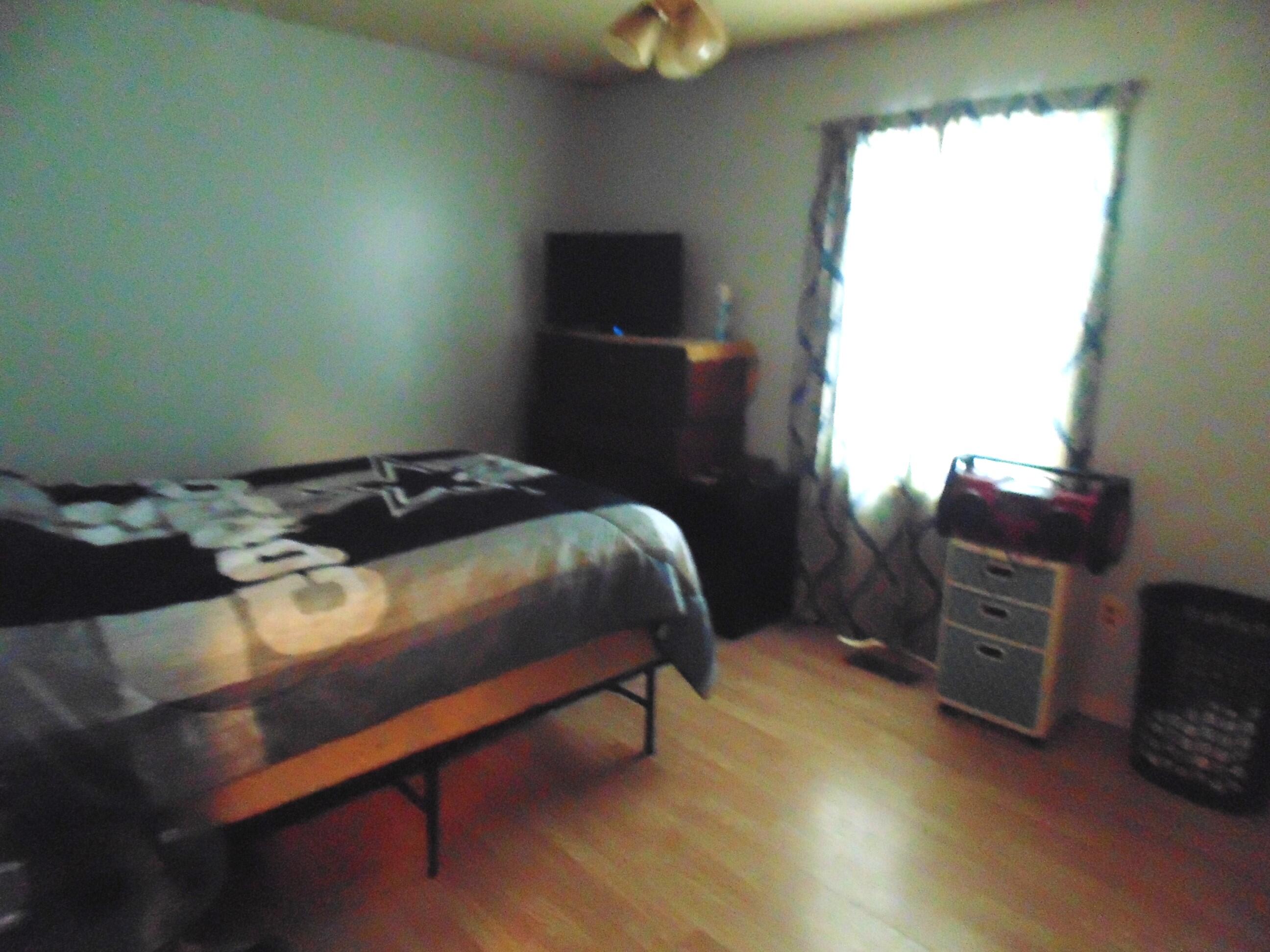 3170 Lawrence Street Hobart, IN 46342 - Photo 9 of 11 a bedroom with a bed and a television