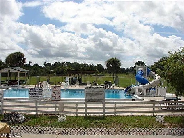 620 South Jasmine Street Clewiston, FL 33440 - Photo 5 of 7 a view of a lake with couches chairs