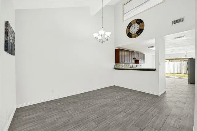 a view of a kitchen with wooden floor and a window