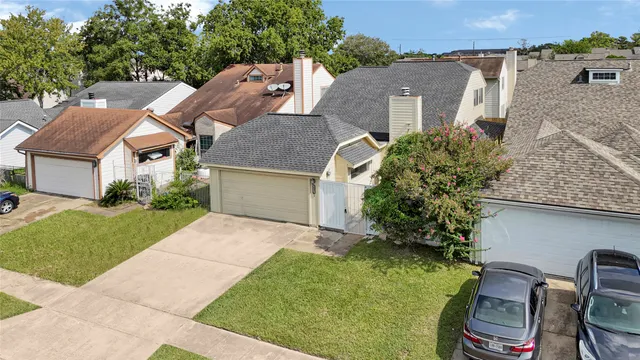 a aerial view of a house with a yard and plants