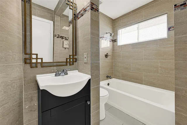 a bathroom with a sink toilet tub and shower