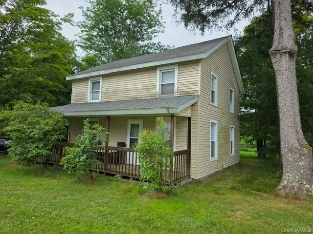 a view of a house with brick walls and a yard with plants