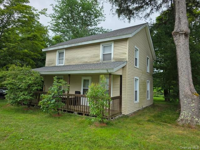 a view of a house with brick walls and a yard with plants