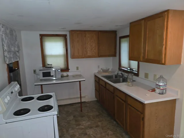 a kitchen with a sink a stove and a refrigerator