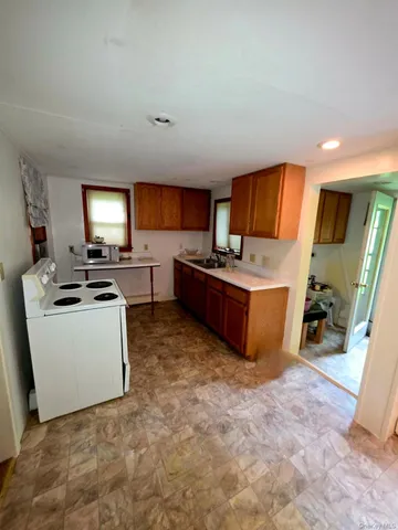 a room with furniture a flat screen tv and appliances