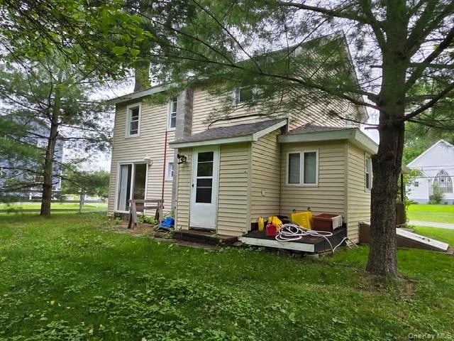 a backyard of a house with table and chairs