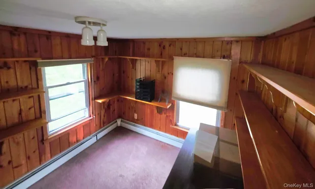 a view of front door and porch with wooden floor