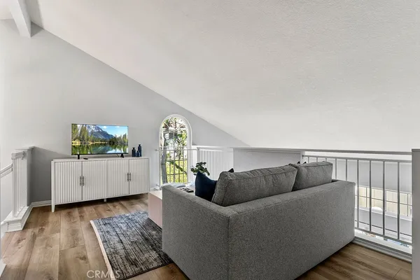 a bedroom with a bed and a chandelier fan