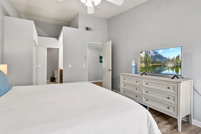 a bedroom with a bed and a dresser