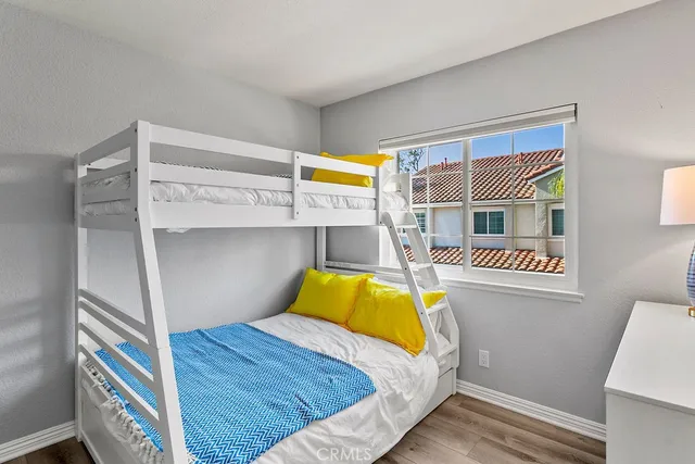 a bedroom with a bed and a painting on the wall