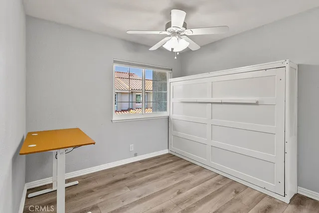 a view of room with window and wooden floor