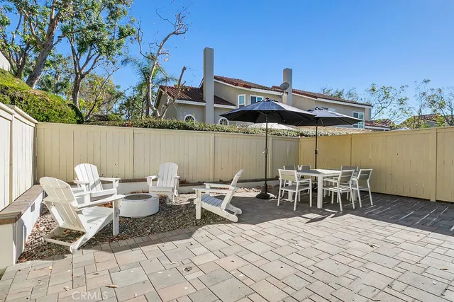 a view of a patio with a table and chairs