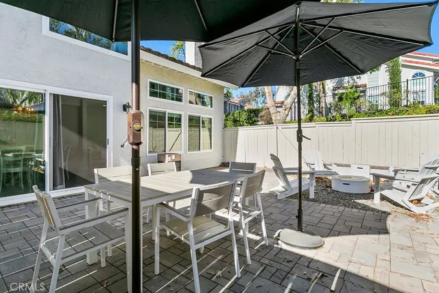 a view of an outdoor space with furniture and umbrella