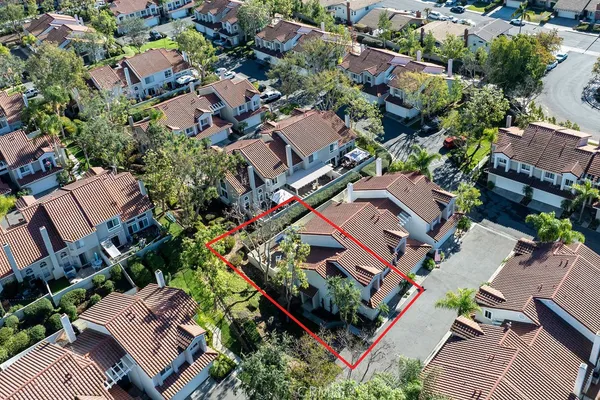 an aerial view of residential houses with outdoor space and lake view