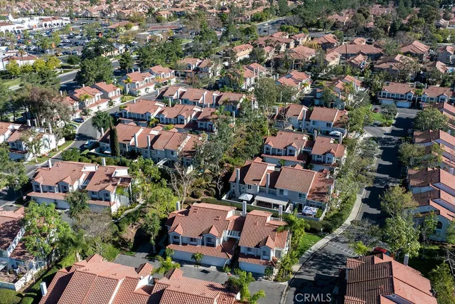 an aerial view of residential houses with outdoor space and lake view
