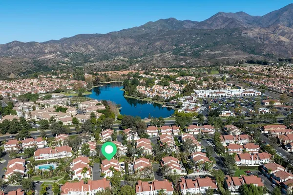 a view of a lake with houses in the back