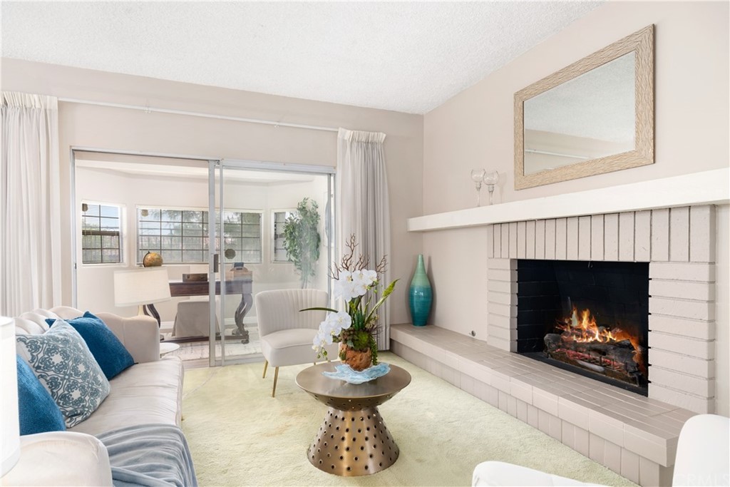 1497 Sunshine Drive Glendale, CA 91208 - Photo 10 of 52 a living room with furniture a fireplace and a large window