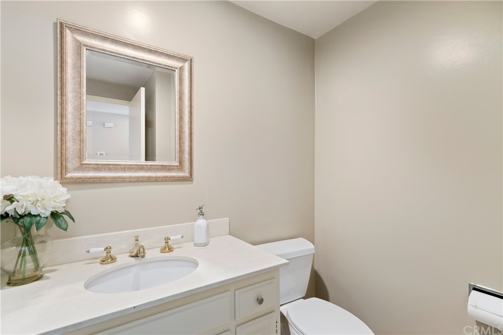 1497 Sunshine Drive Glendale, CA 91208 - Photo 9 of 52 a bathroom with a toilet sink and mirror