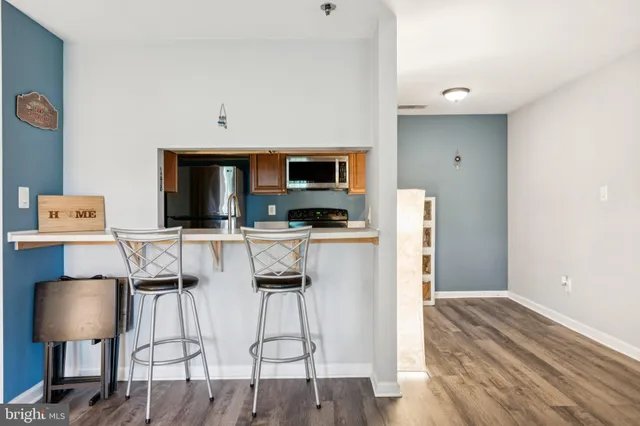 a kitchen with stainless steel appliances a microwave a stove and refrigerator