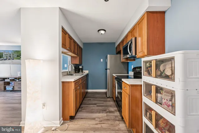 a kitchen with stainless steel appliances granite countertop a stove and a refrigerator
