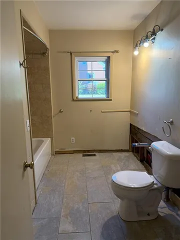 a bathroom with a toilet sink and shower
