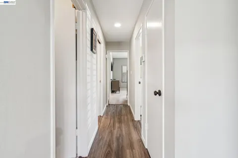 a view of hallway with wooden floor