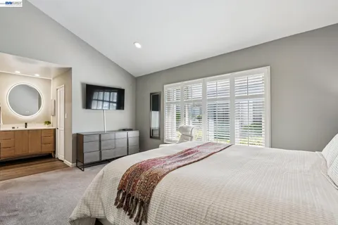 a bedroom with a large bed and a window