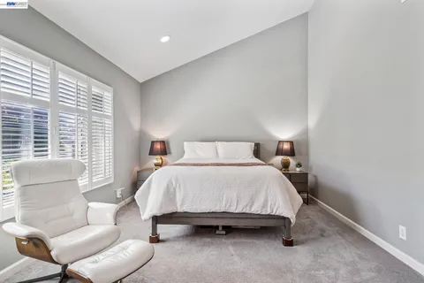 a bedroom with a bed and a couch