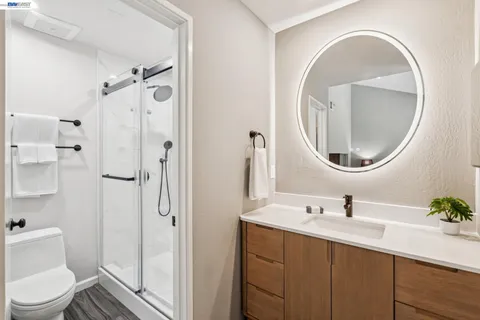 a bathroom with a sink a toilet and a mirror
