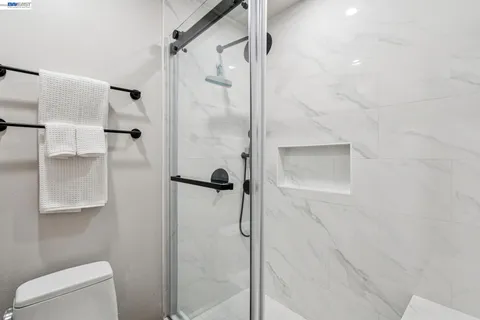 a bathroom with a shower and toilet