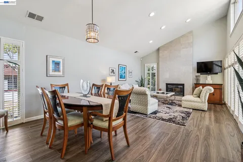 a view of a dining room with furniture wooden floor and a chandelier