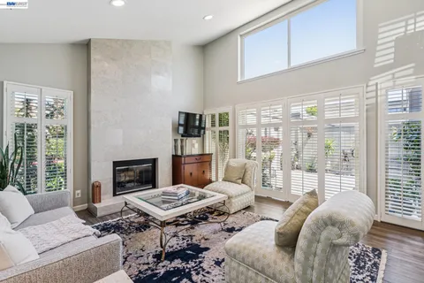 a living room with furniture fireplace and a table