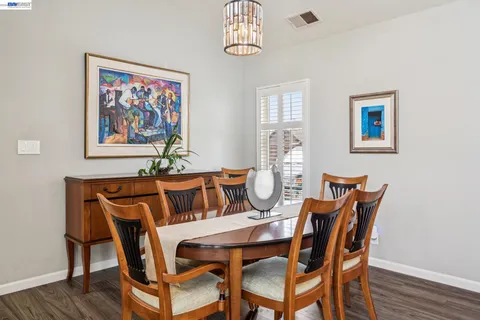 a view of a dining room with furniture wooden floor and a window