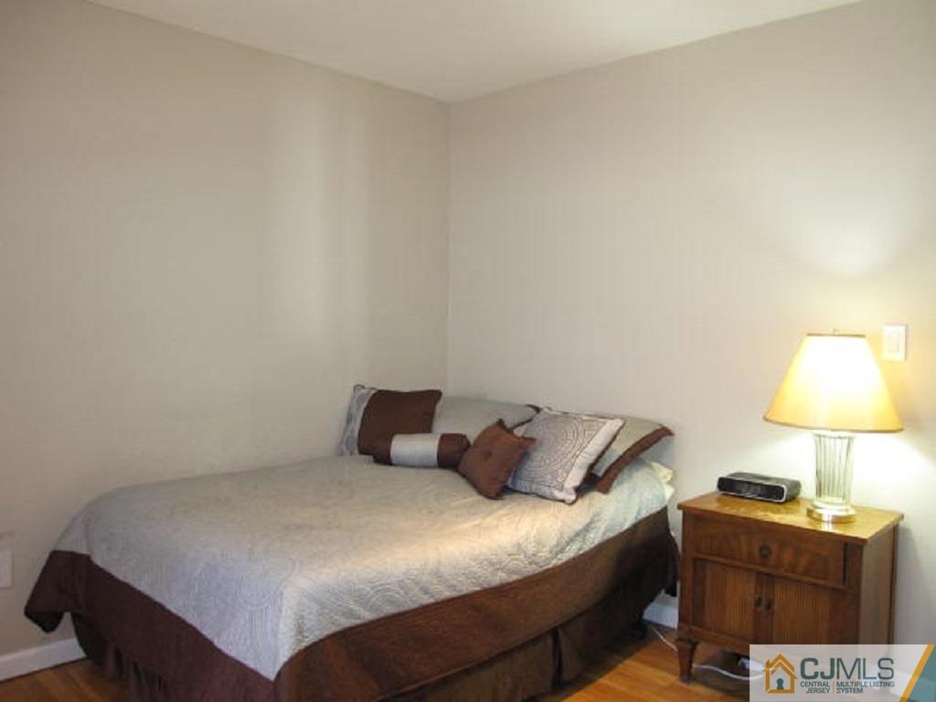 20 Mockingbird Road Edison, NJ 08820 - Photo 12 of 18 a bedroom with a bed and a lamp