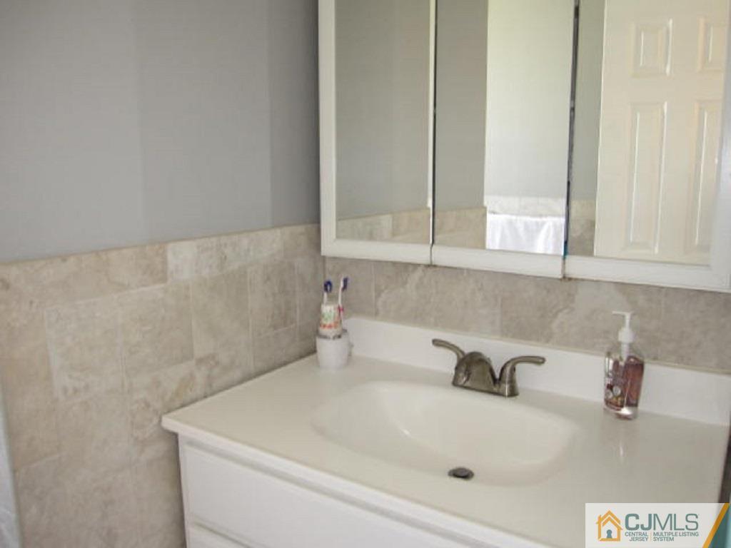 20 Mockingbird Road Edison, NJ 08820 - Photo 15 of 18 a bathroom with a sink and vanity