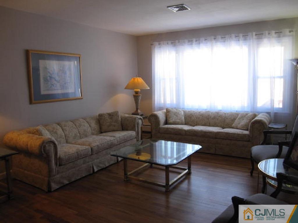 20 Mockingbird Road Edison, NJ 08820 - Photo 3 of 18 a living room with furniture a window and a table