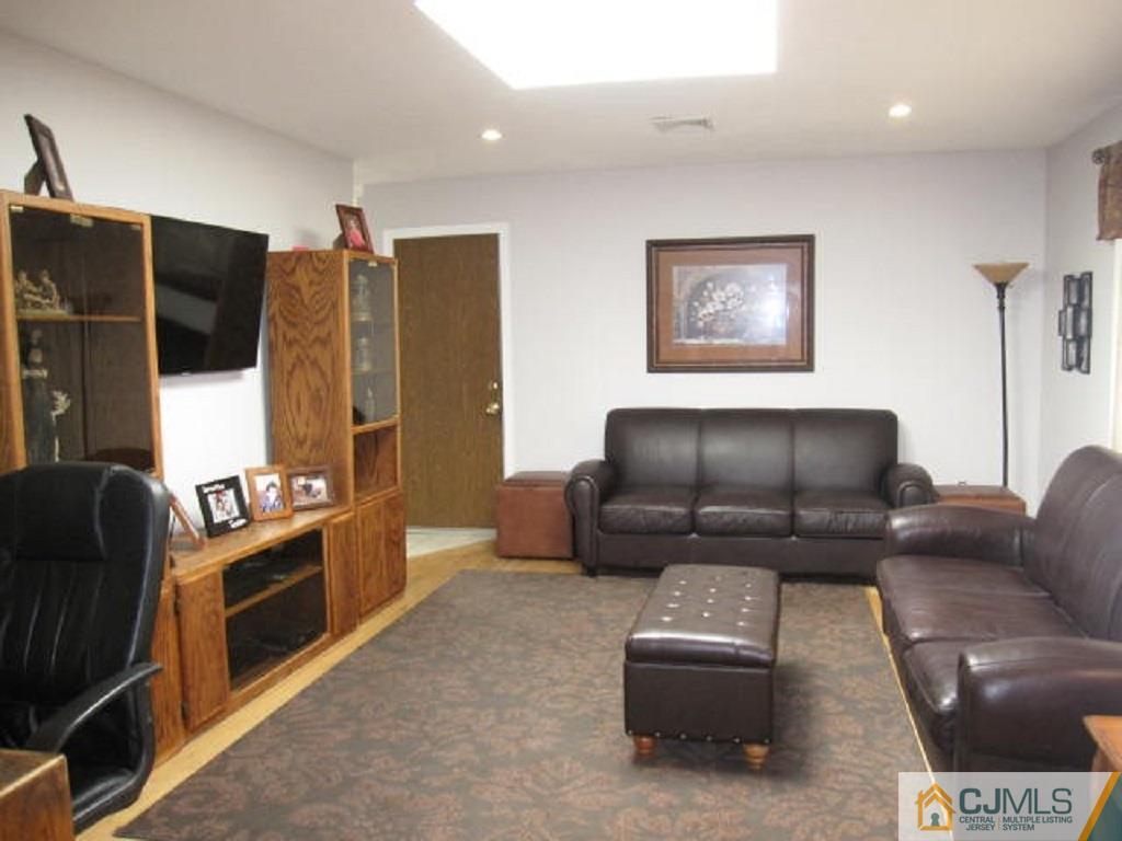 20 Mockingbird Road Edison, NJ 08820 - Photo 5 of 18 a living room with furniture and a flat screen tv