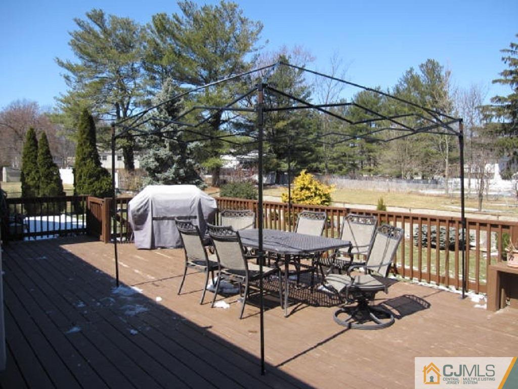 20 Mockingbird Road Edison, NJ 08820 - Photo 9 of 18 a view of a chairs and table on the wooden deck